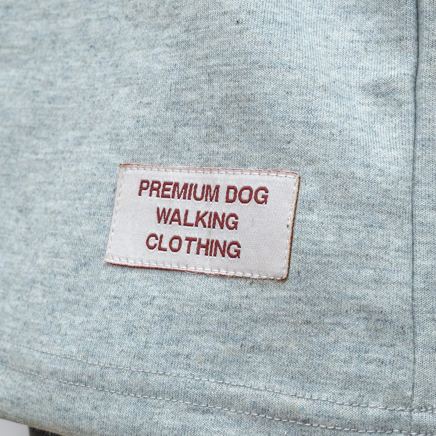 Gray fabric with a label reading 'Premium Dog Walking Clothing' on a gray background