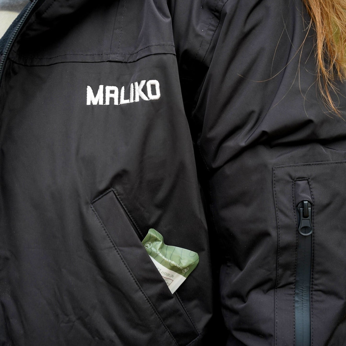 Black waterproof jacket with 'MALIKO' branding on a person wearing it.