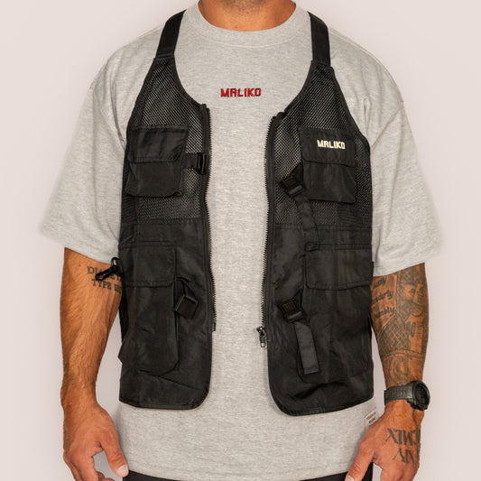 Man wearing a black vest and gray t-shirt with 'Maliko' branding on a white background