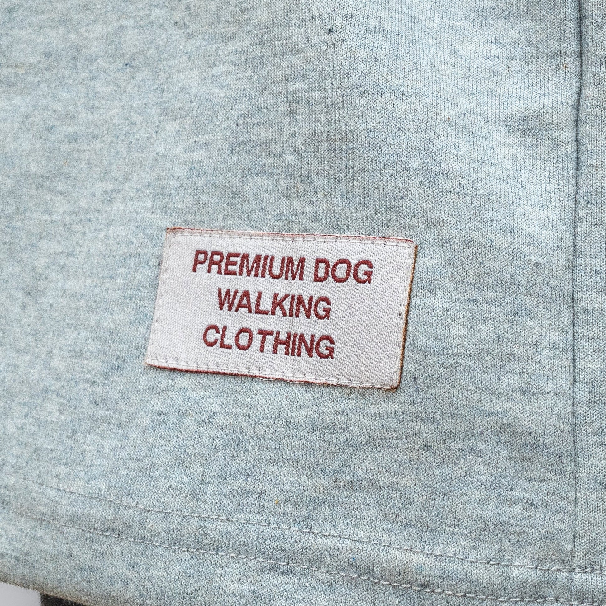 Gray fabric with a label reading 'Premium Dog Walking Clothing' on a gray background