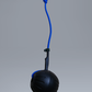 Black ball with a blue rope on a gray background