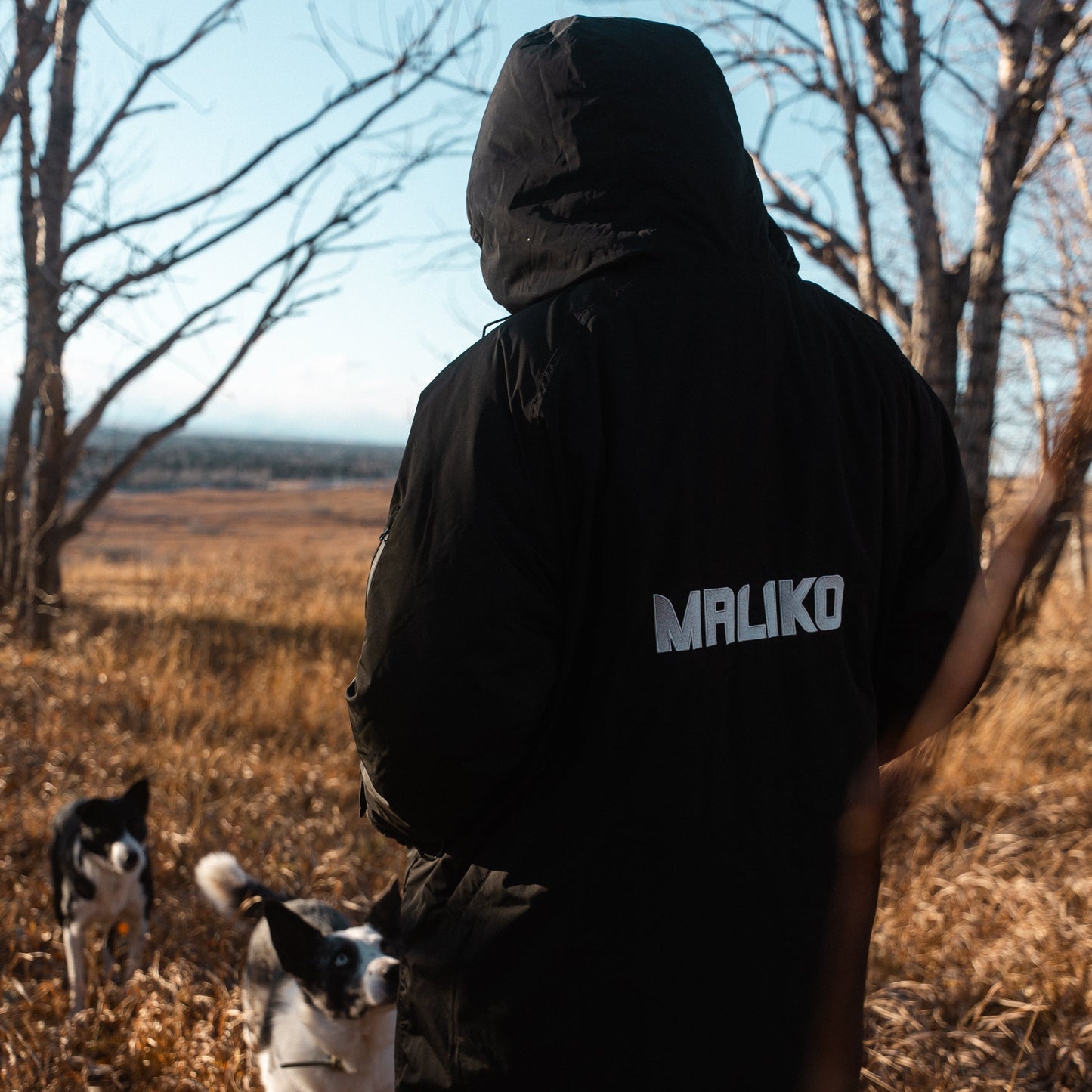 woman with dogs wearing maliko robe coat
