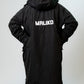 A person viewed from behind wearing a long black hooded jacket with the brand name 'MALIKO' printed in white across the back, against a plain light gray studio background.