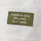 White t shirt with a green label on a gray background
