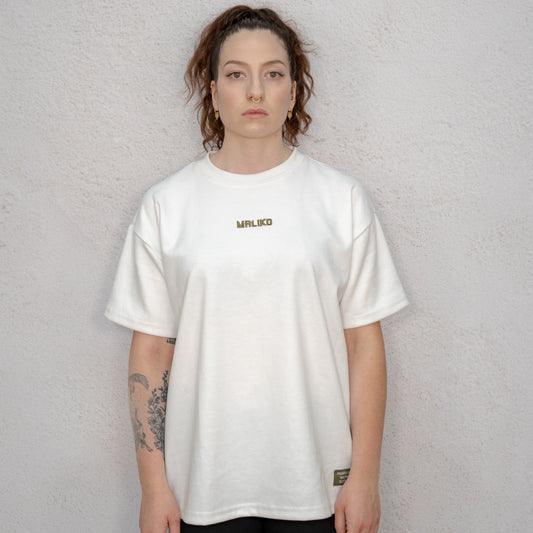 Person wearing a white t-shirt with a logo on a plain background